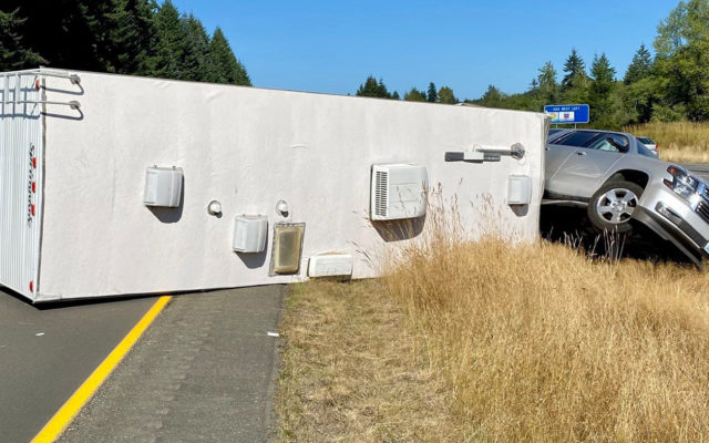 Overturned travel trailer blocks traffic